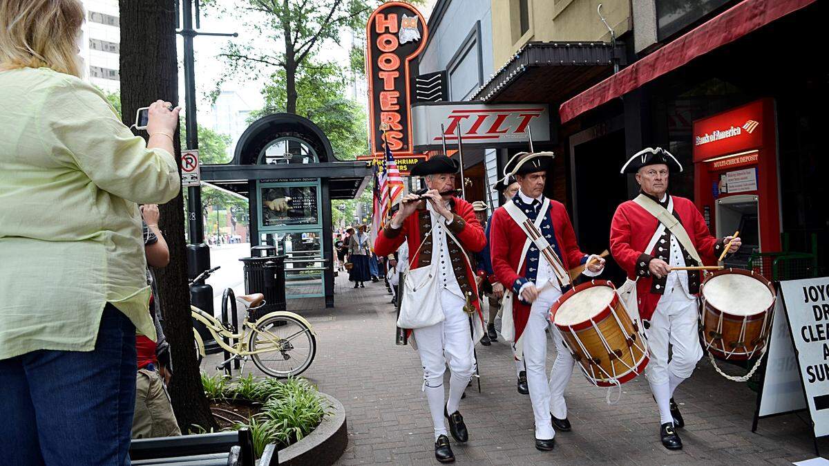 Members of the 6th North Carolina Continental Line march west on Trade Street after ceremonies by the May 20th Society commemorated the 237th anniversary of the signing of the Mecklenburg Declaration of Independence at Trade and Tryon Streets on Friday, May, 18. 2012. Hundreds of people witnessed the celebrations where about 20 military and colonial re-enactors marched, played pipes and drums and fired black powder weapons including a cannon. John D. Simmons - jsimmons@charlotteobserver.com