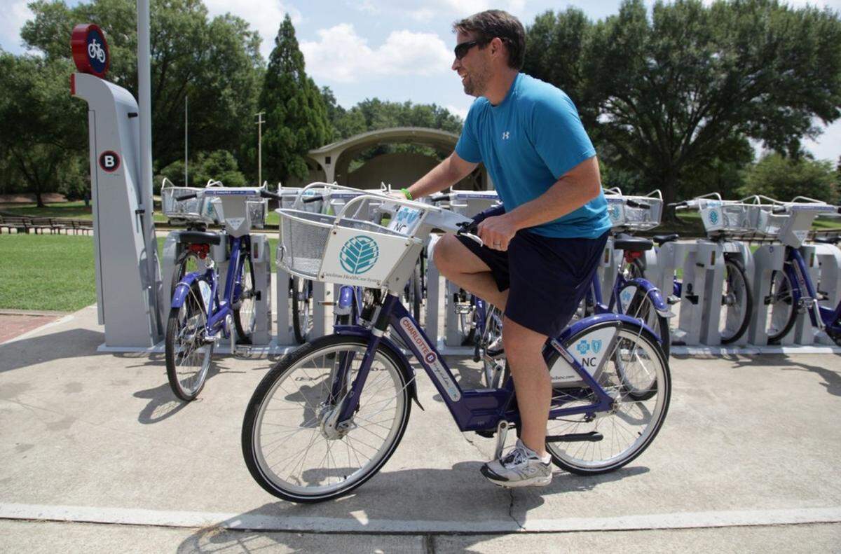 Andy Mock takes a bike for a ride from the Charlotte B-cycle station at Freedom Park on Monday, July 29, 2013. "These bikes saved me. I used to have to take my bike to work, which was kind of a hassle," says Mock. He purchased a year-long membership so he can use the bikes whenever he needs them. Charlotte B-cycle is a bike sharing system with 200 bicycles and 20 stations spread out around Charlotte. It is celebrating its one year anniversary this week.__MORGAN MCCLOY-mmccloy@charlotteobserver.com