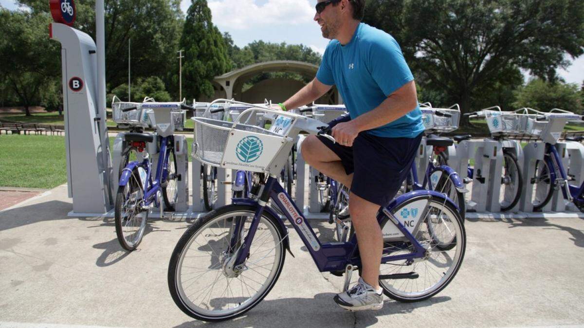 Andy Mock takes a bike for a ride from the Charlotte B-cycle station at Freedom Park on Monday, July 29, 2013. "These bikes saved me. I used to have to take my bike to work, which was kind of a hassle," says Mock. He purchased a year-long membership so he can use the bikes whenever he needs them. Charlotte B-cycle is a bike sharing system with 200 bicycles and 20 stations spread out around Charlotte. It is celebrating its one year anniversary this week.__MORGAN MCCLOY-mmccloy@charlotteobserver.com