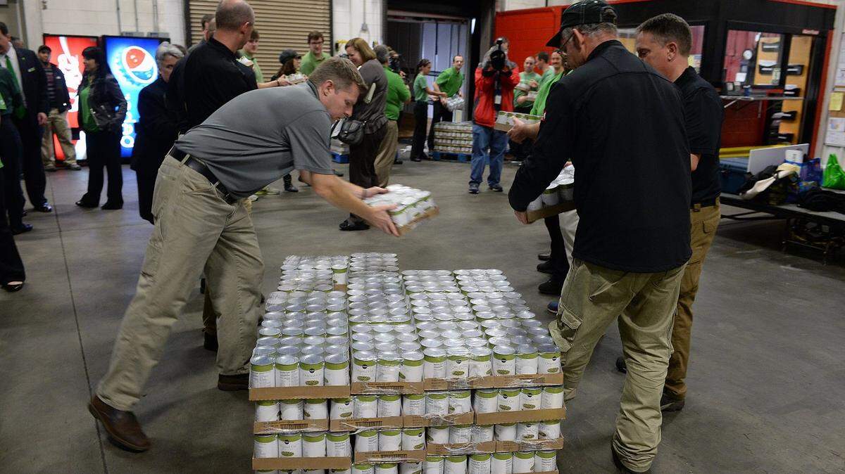 Staff members from Second Harvest Food Bank of Metrolina and Publix's staff  came together to help organize and stack can goods donated by Publix to the Food Bank.
In an effort to help with transportation needs and the ability of the Food Bank to increase its capacity of the types of food it can pick up from retailers, Publix is donating $120,000 to go toward buying a 30-foot refrigerated truck. Also, to help families fill their pantries before the holidays, Publix is also donating a truck load of protein and other foods valued at $55,000.