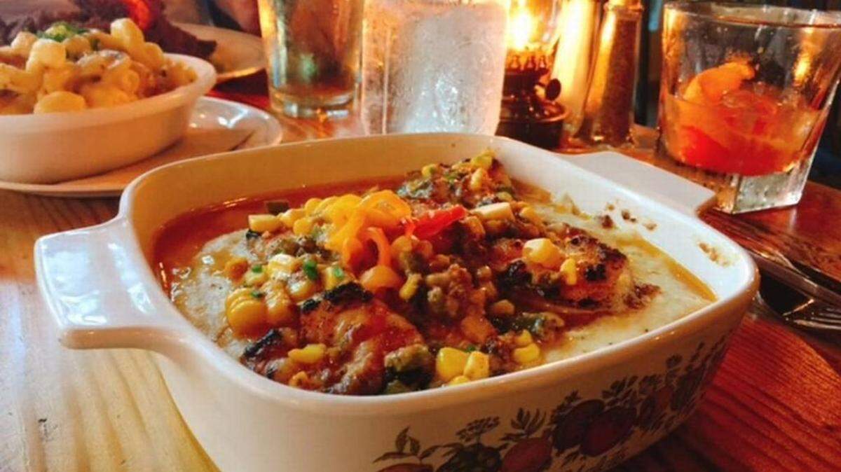 The shrimp & grits arrive in a 1970s-era casserole dish.