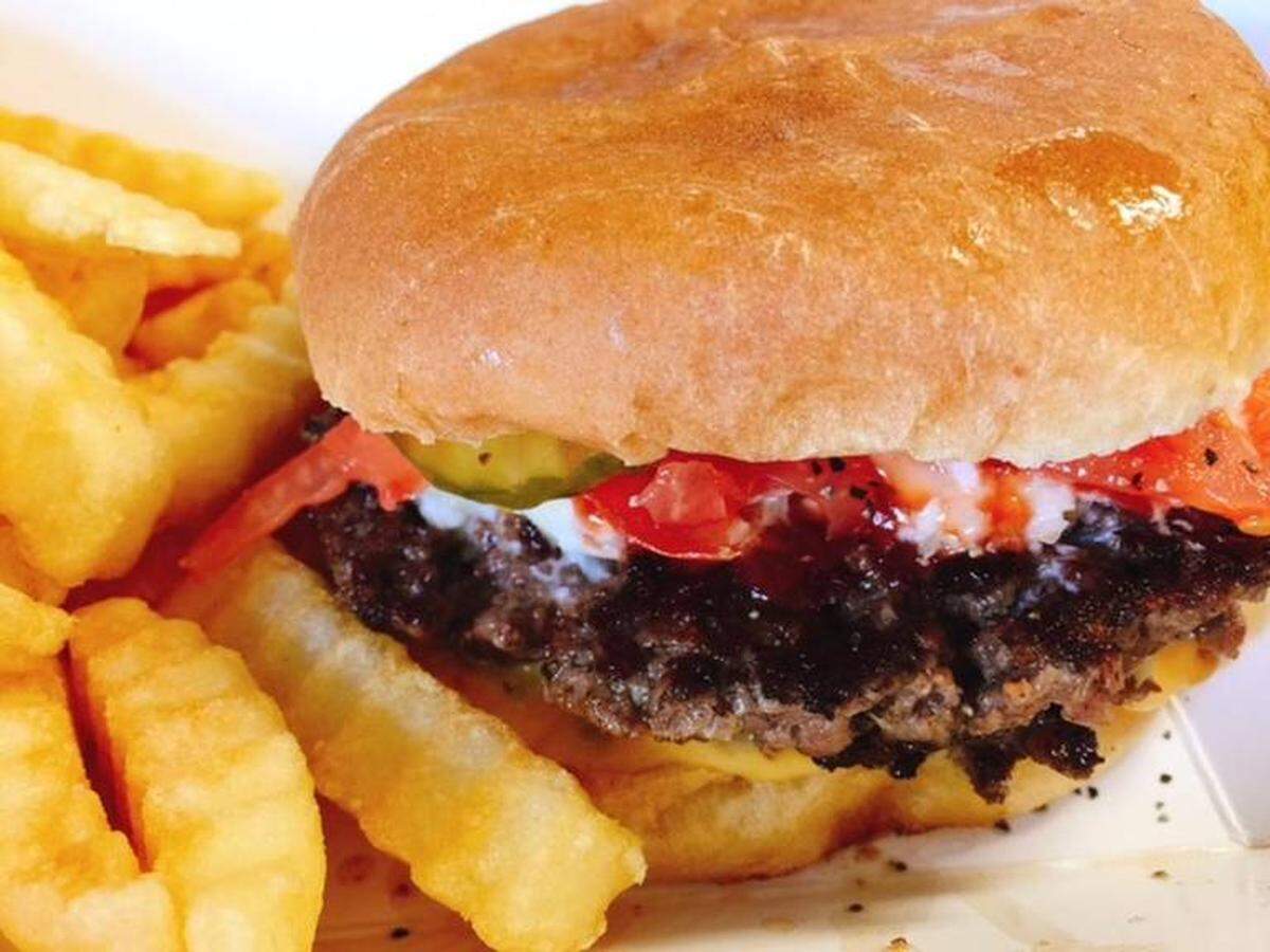 The Bright Star’s burger has dark, crusty edges and plenty of juicy coleslaw.