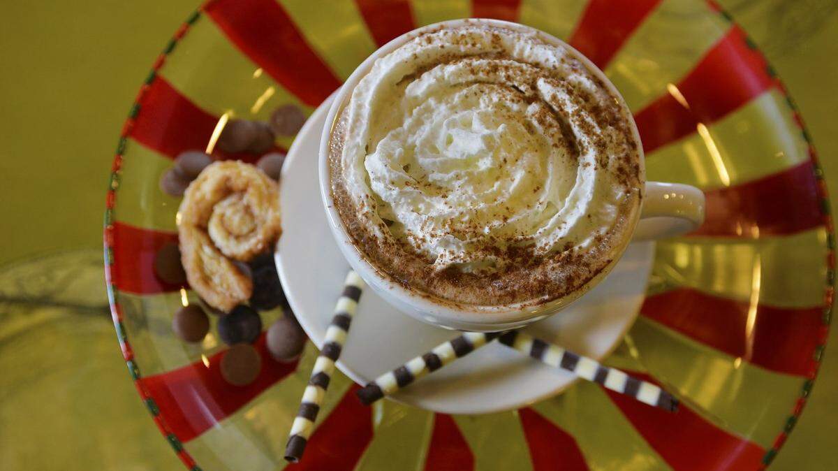 Amelie's in-house hot chocolat chaud with whip cream and a peri palmier.