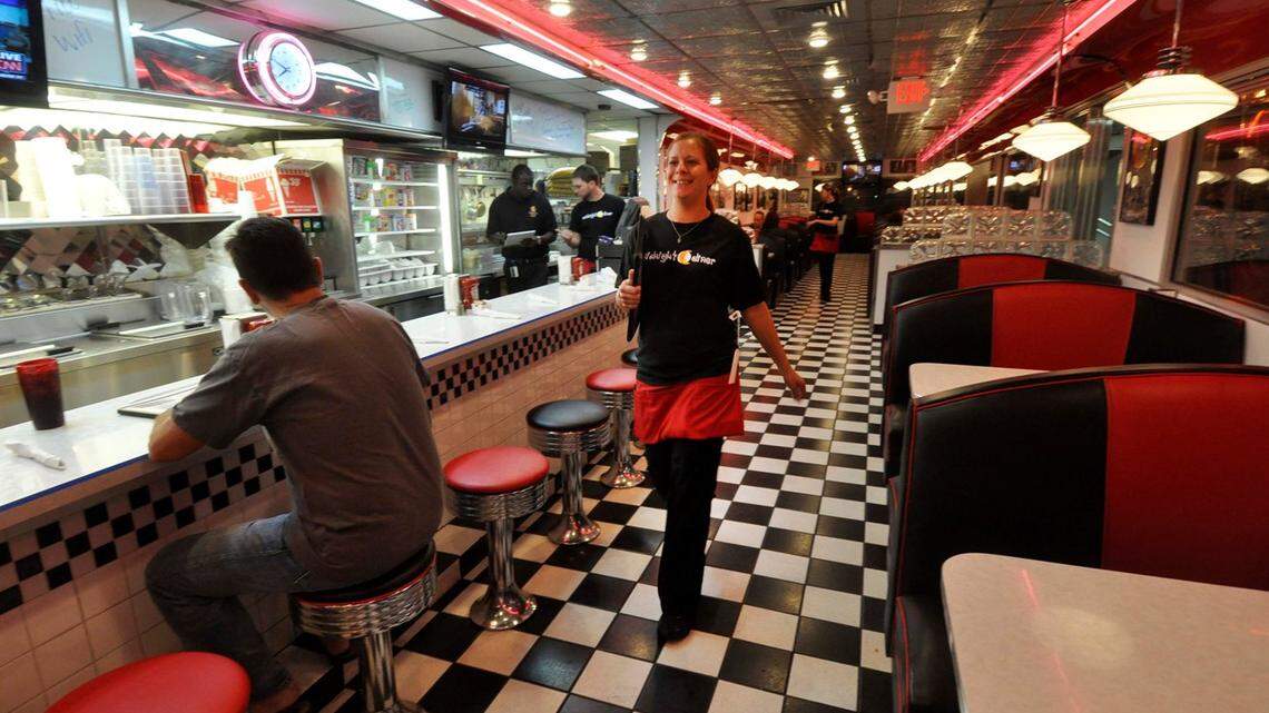 Midnight Diner waitress Bonnie Owens takes menus to customers. The diner is open 24/7.