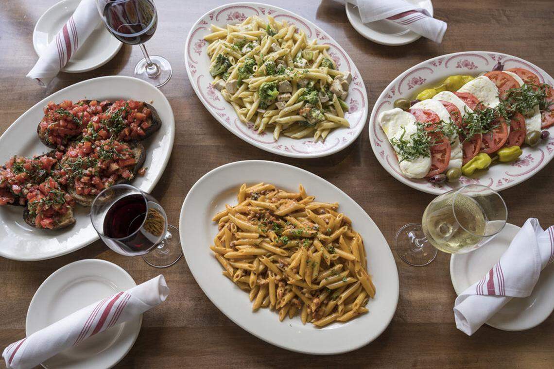 Family-style dining at Mama Ricotta’s with a glass of red or white.