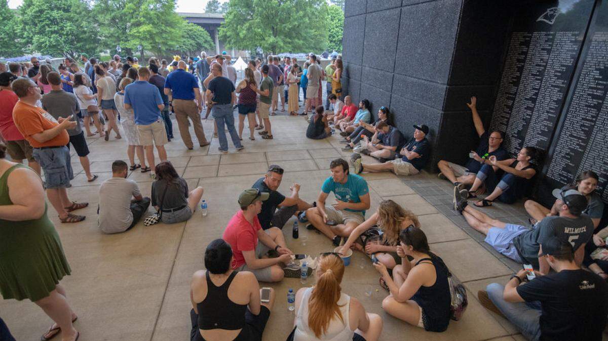 Photo by Alex Cason Photography Untappd Beer Festival attendees wait out the storm delay inside the concourse at Bank of America Stadium.