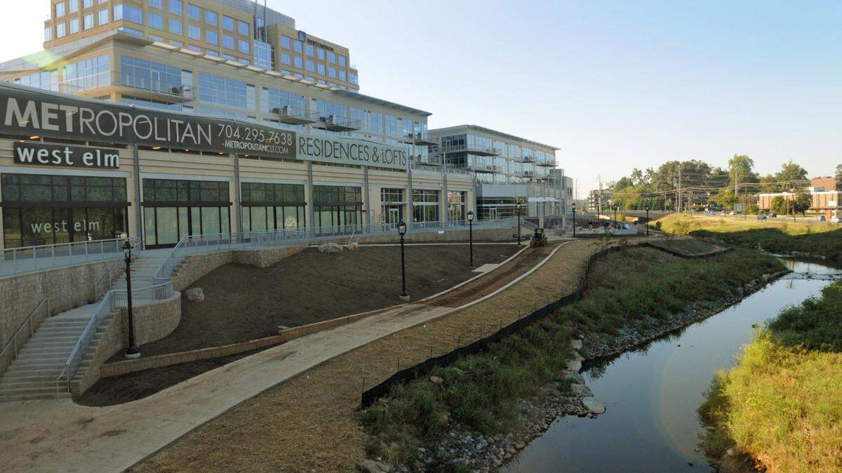 9/30/09  The  Little Sugar Creek Greenway project at the mixed-use Metropolitan development is progressing but behind schedule. Street lamps and a course for the trail are in place, but construction didn't wrap up by summer's end, as planned. DAVIE HINSHAW - dhinshaw@charlotteobserver.com.