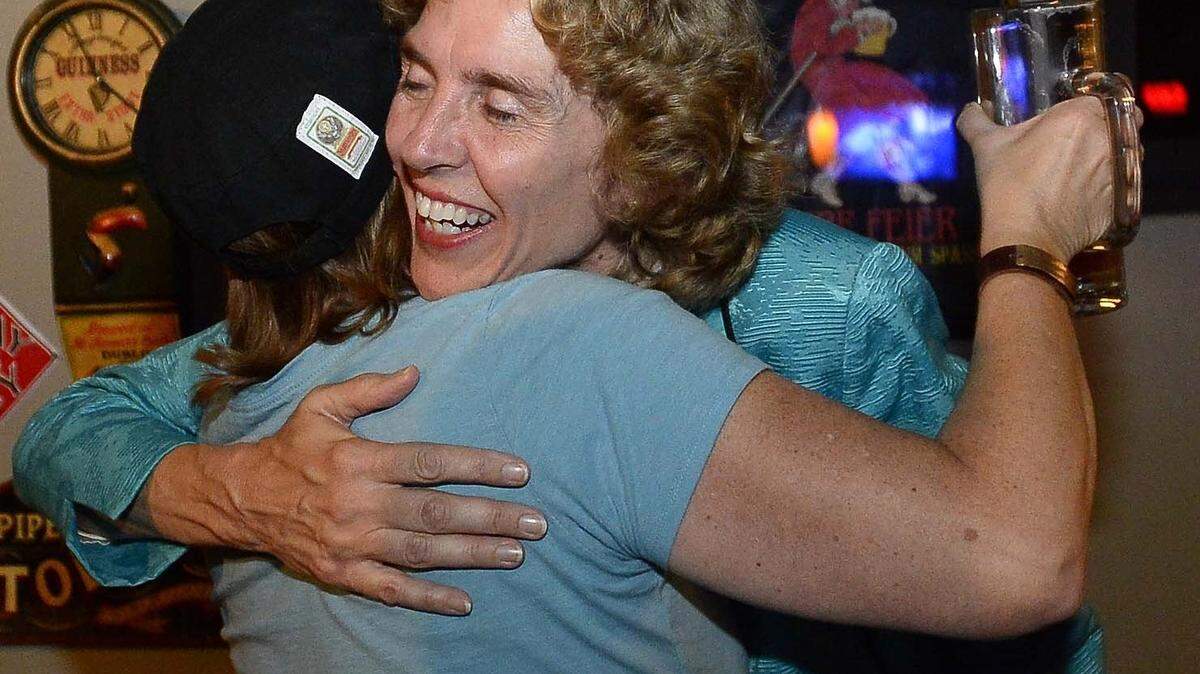 Jennifer Roberts receives a hug from supporter Karen Moseley at The Peculiar Rabbit on Tuesday Sept.15,2015.