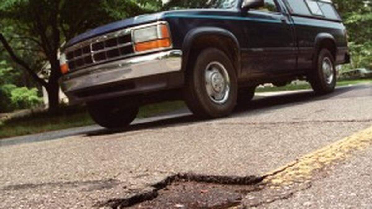 Potholes like this one in Mecklenburg County can be found on roads across the Charlotte area and across the state.