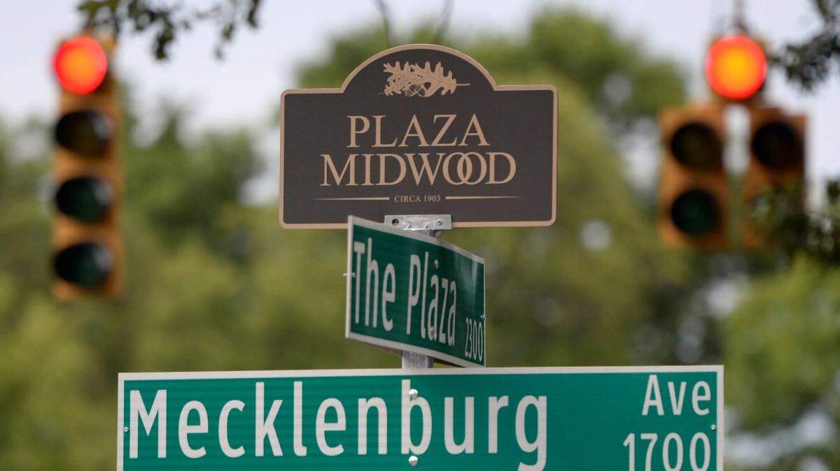 A Plaza Midwood neighborhood marker tops a street sign along The Plaza on Tuesday, July 14, 2015.