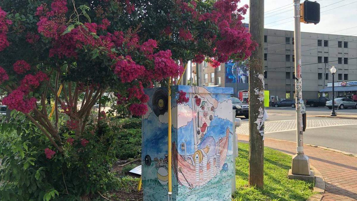 Courtesy of Plaza Midwood Neighborhood Association<br/>Local artist and Plaza Midwood resident Melissa Wineman submitted “Adventures in the Hood” for the signal box wrap project that depicts a whimsical fantasy world full of references to iconic neighborhood businesses. It can be found at Central Avenue and Pecan Avenue.