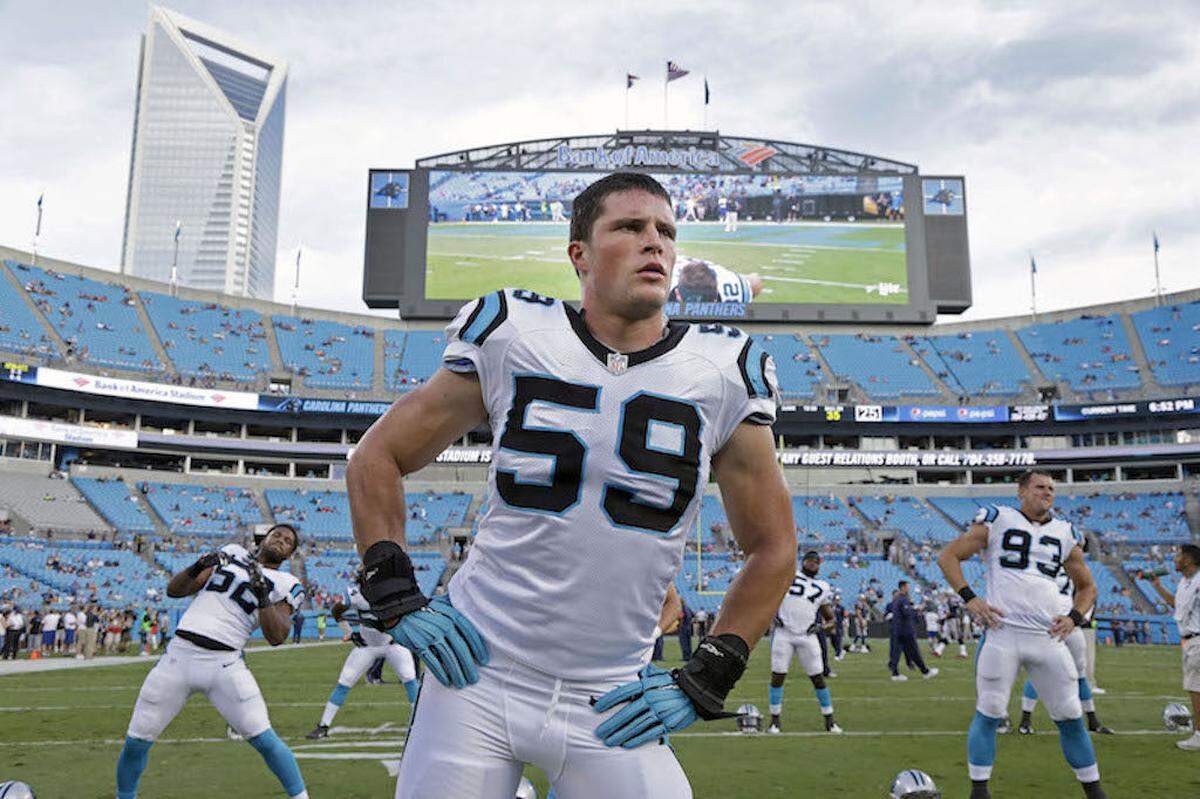 In this photo taken Aug. 28, 2015,  Carolina Panthers' Luke Kuechly (59) stretches before a preseason NFL football game against the New England Patriots in Charlotte, N.C. A person familiar with the situation says Luke Kuechly has agreed to a five-year $52 million contract extention with the Panthers, making him the highest-paid middle linebacker in the NFL. The person spoke to The Associated Press on Thursday, Sept. 10, 2015, on condition of anonymity because the move hasn't been announced. (AP Photo/Bob Leverone)