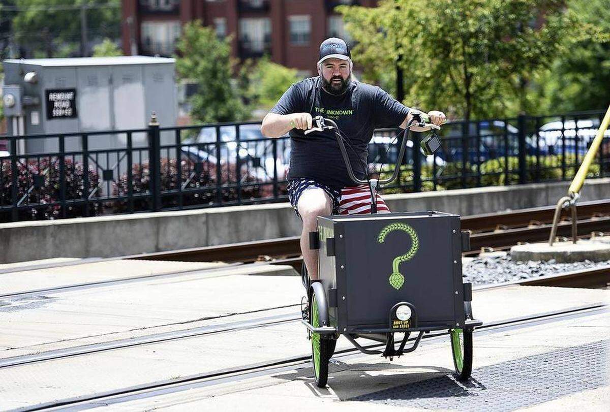 Brad Shell, owner and head brewer of The Unknown Brewing Co., crossed the light rail line on Remount Road.
