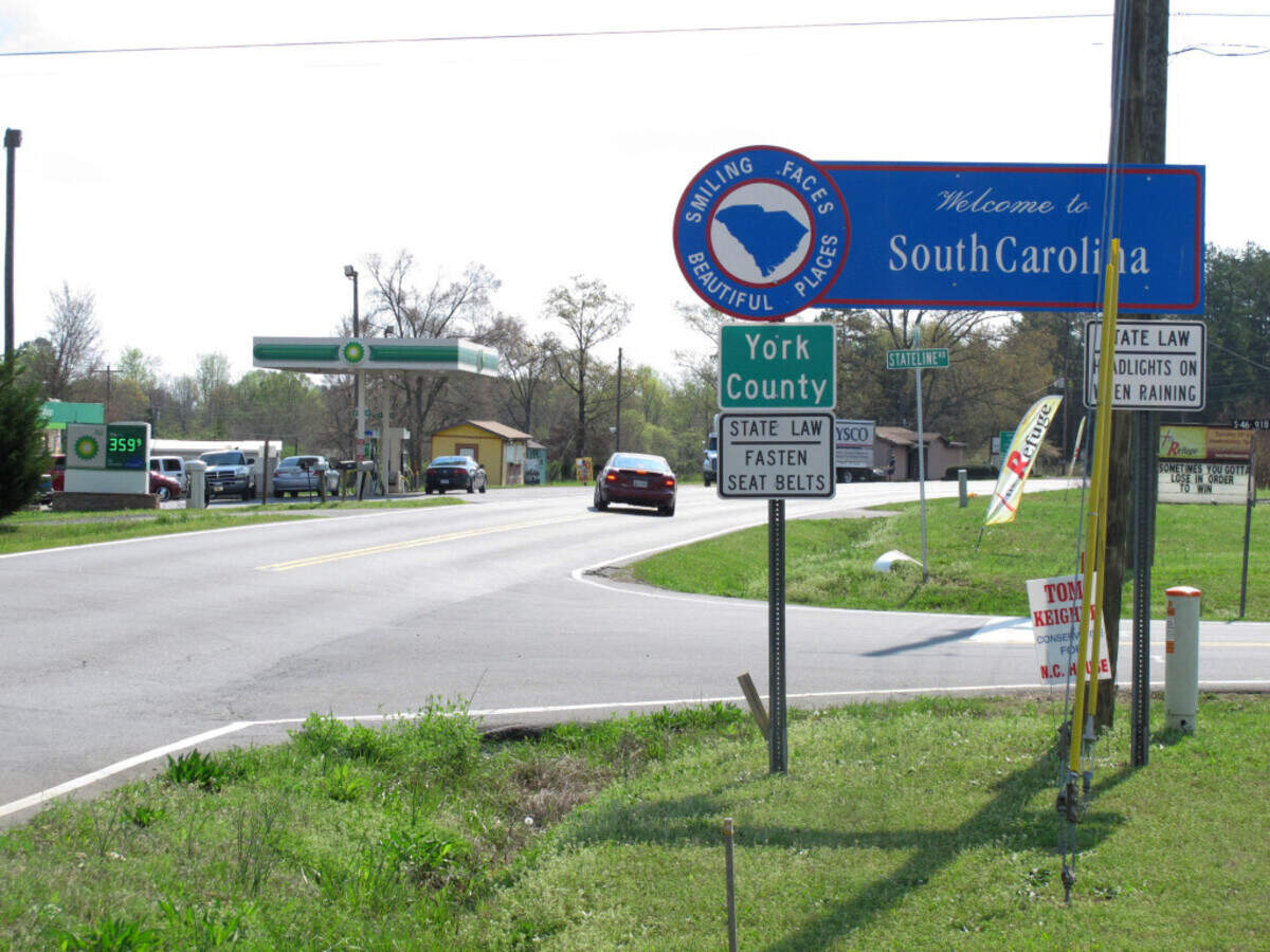 A car coming from North Carolina turns into the Lake Wylie Minimart in Lake Wylie, S.C. on Wednesday, March 21, 2012. The store's owner thought his business was in South Carolina, but surveyors have determined it is actually in North Carolina, meaning his gas prices will likely go up 30 cents and he can't sell fireworks. (AP Photo/Jeffrey Collins)