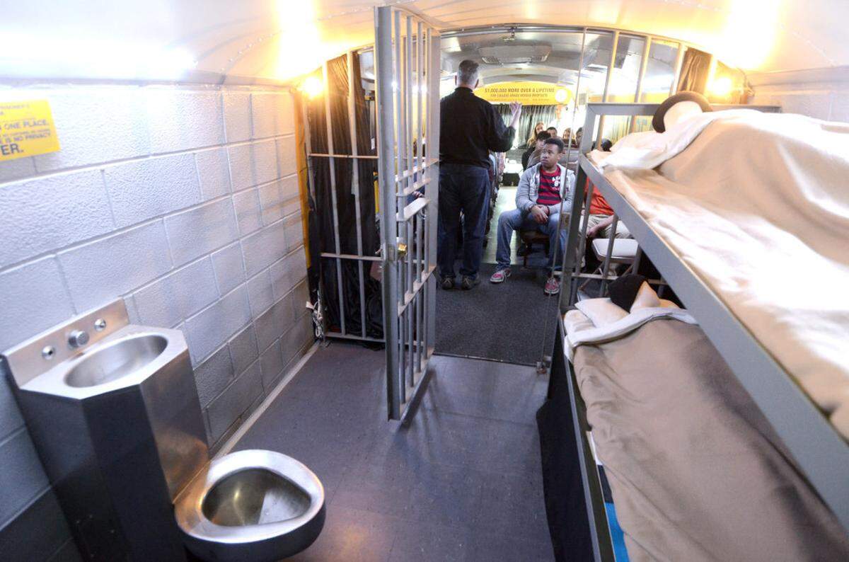 Chet Pennock of The Mattie C. Stewart Foundation speaks to students in the Choice Bus about the consequences of their choices in life before showing them the exact replica of a prison cell (foreground) in the back of the bus during Wednesday's Choice Bus appearance at the Performance Learning Center on N. Graham St. Charlotte students are boarding The Choice Bus this week - a half-classroom, half-prison cell mobile experience dedicated to reducing the dropout rate in the U.S. The Mattie C. Stewart Foundation's Choice Bus has touched the lives of more than two million people in 20 states, sharing the powerful message of what education can bring - at least $1 million over a person's lifetime if they graduate from college. Did you know that every 26 seconds across America, a student drops out of high school? And the period between semesters at the winter break is often when students drop out? The Choice Bus is the nation's first mobile experience dedicated to showing students the power of their choices. Charlotte students will have the opportunity to board the bus from Tuesday, April 8 through Thursday, April 10.