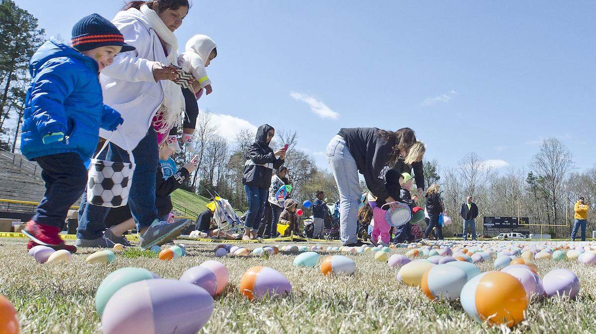 Grayson Medure (cq), 2, left, follows the youngest group onto the field full of eggs during "The county's largest Easter egg hunt" at the Concord High football stadium on March 28.  03-28-15  Six local churches joined with Mission 217 Church, of Kannapolis, to hold "The county's largest Easter egg hunt" at Concord High School.