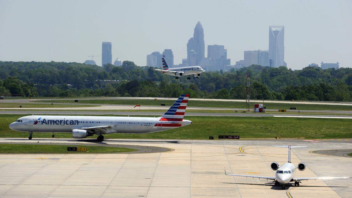 A view from atop the new Hourly Deck and Consolidated Rental Car Facility at Charlotte-Douglas International Airport as airplanes land and prepare to take off, on Monday, May 4, 2015. The completion of the parking facility marks the completion of CLT 2015, a multi-year development campaign at the airport.