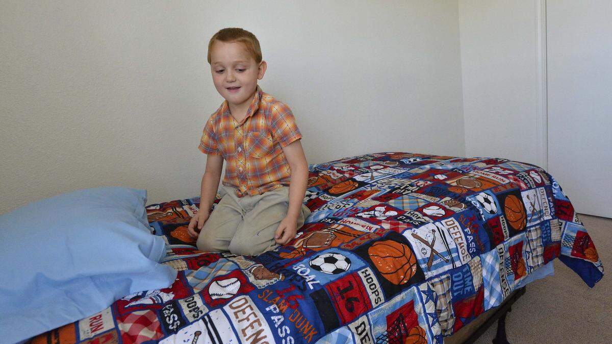 5-year-old Isaac Fortich looks over the baseball theme comforter in his bedroom at Piedmont Pointe Apartments in Mooresville on April 16,2014. Brenda Hawkins was saddened to learn recently that some families in her town are so poor that they can’t afford beds for their children. The kids sleep four to a bed in some cases or on old mattresses on the floor or in the same bed as their parent/s. Hawkins, president of the 15-member Mooresville Rotary Club, coaxed her club into donating $2,500 for new beds for kids, which was matched by a private local foundation. The volunteers have delivered seven or eight beds to families since Jan. 1.