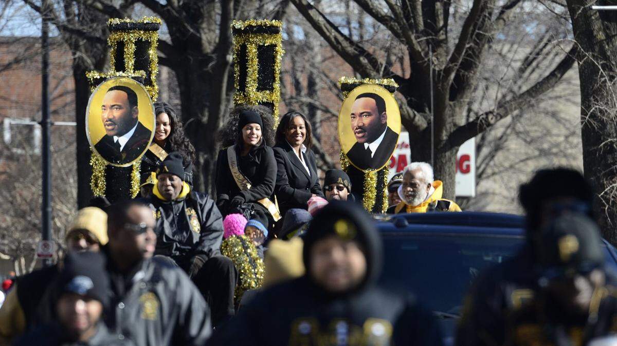 John D. Simmons/Charlotte Observer<br/>Alpha Phi Alpha Fraternity, Inc.'s float makes its way down Tryon Street on Saturday, January 18, 2014.