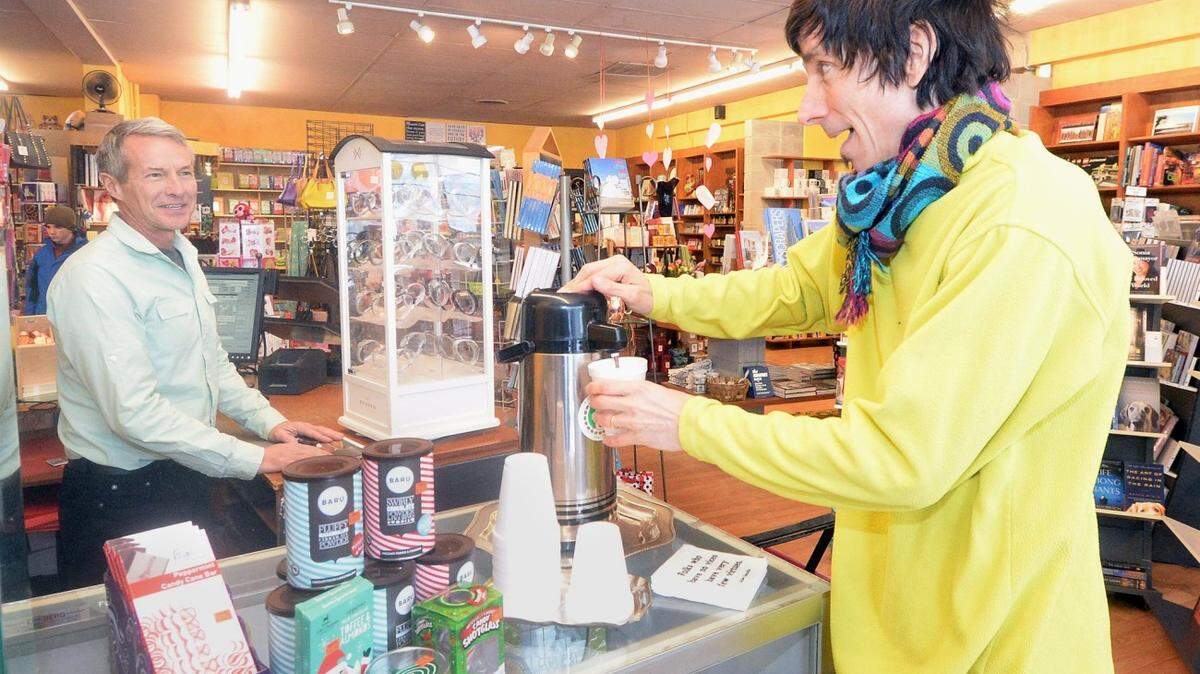 Mitchell Kearney serves himself free hot chocolate at Paper Skyscraper, 330 East Blvd. (At left is Paper Skyscraper co-owner Ron Wootten). As a major winter storm descended on the Charlotte region Wednesday, retailers were hoping Valentine's Day wouldn't turn out to be a heartbreaker.  To lure shoppers in, The co-owner, Ron Wootten,  is offering free hot chocolate today.