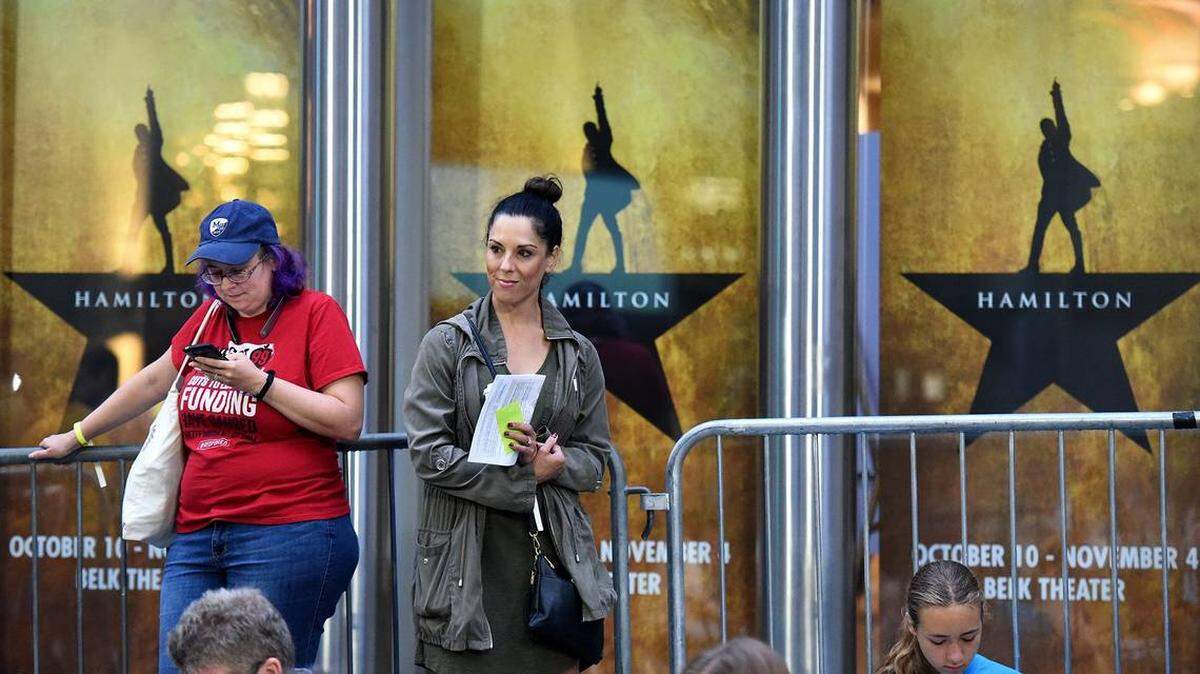 Bethany Dykstra of Charlotte and Christine Smith-Barker of Davidson wait outside Belk Theater on Aug. 1, when tickets went on sale for the national tour of Broadway’s “Hamilton.” Photo by John D. Simmons