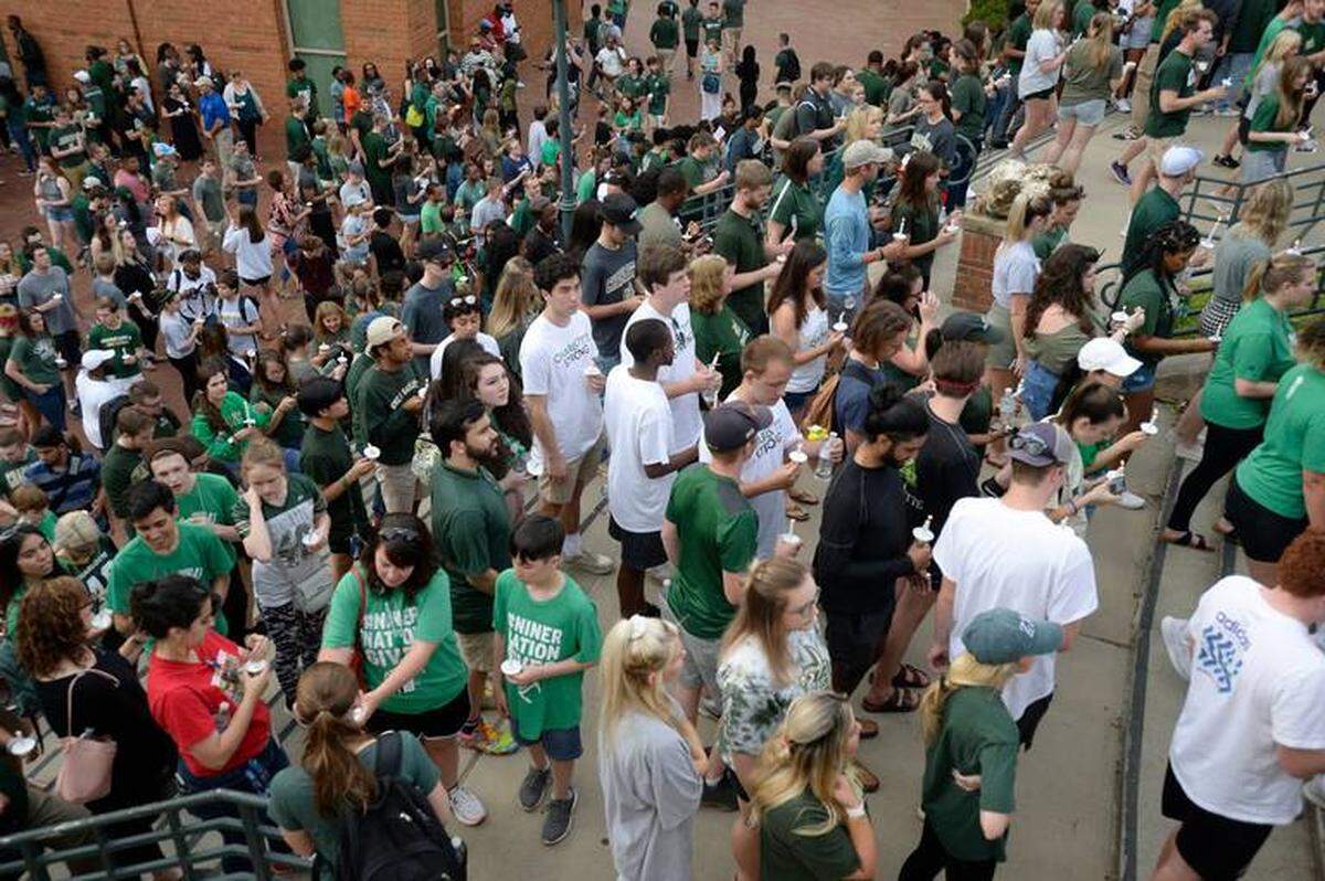 David Foster / Charlotte Observer<br/>UNC Charlotte students light candles and assemble near Halton Arena during a vigil on Wednesday, May 1, 2019 in memory of the students killed during a campus shooting on Tuesday.