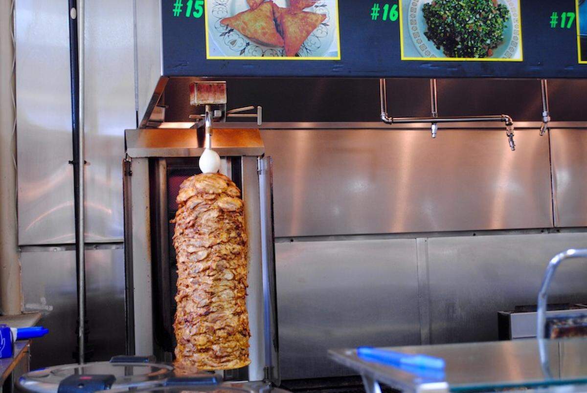 Chicken shawarma browns on the spit at La Shish Kabob.