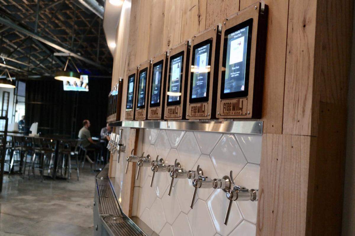 Photo by Jennings Cool<br>The beer wall at Free Will Craft + Vine