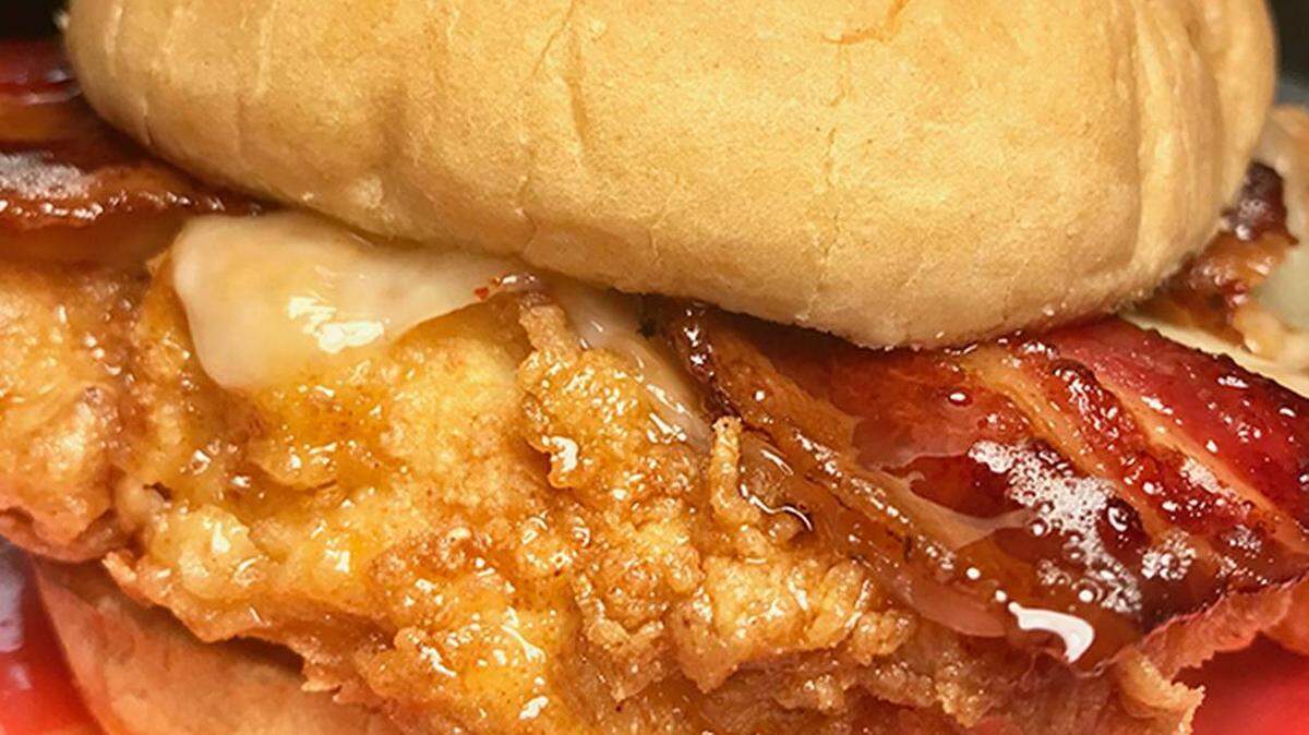 Courtesy of Chef's D'lites<br>Say hello to The Chickonator, a fried chicken breast between two honey butter buns, topped with bacon and honey sauce.