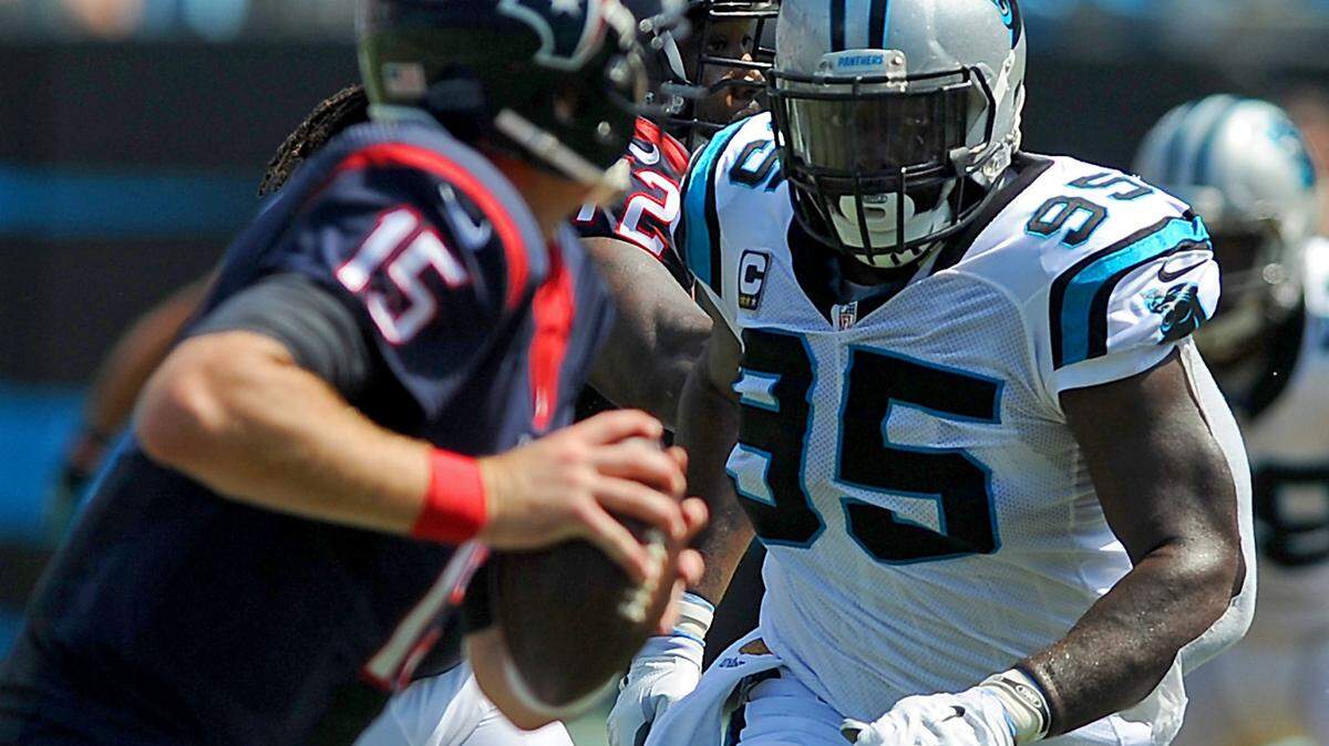 Carolina Panthers defensive end Charles Johnson, right, chases after Houston Texans quarterback Ryan Mallett, left, during second quarter action at Bank of America Stadium in Charlotte, NC on Sunday, September 20, 2015. The Panthers defeated the Texans 24-17.