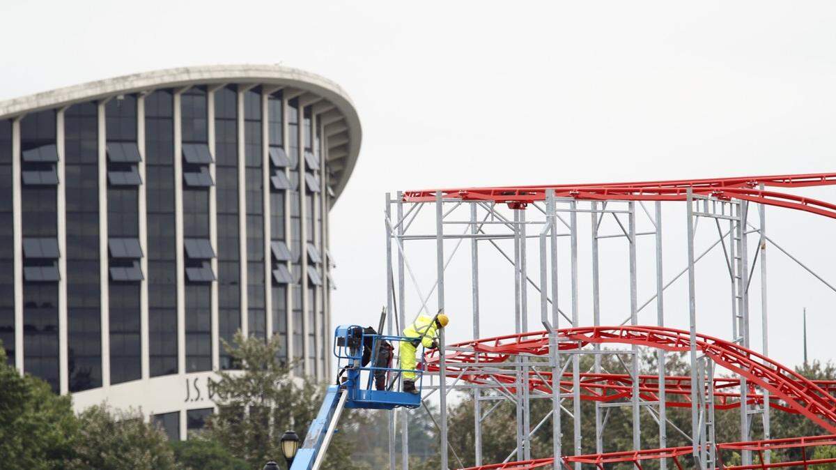 With the landmark Dorton Arena in the background, workers set up the Super Cyclone roller coaster ride for the upcoming N.C. State Fair at the Fairgrounds in west Raleigh on Oct. 5, 2015. This year the State Fair runs Oct 15 - 25, 2015.