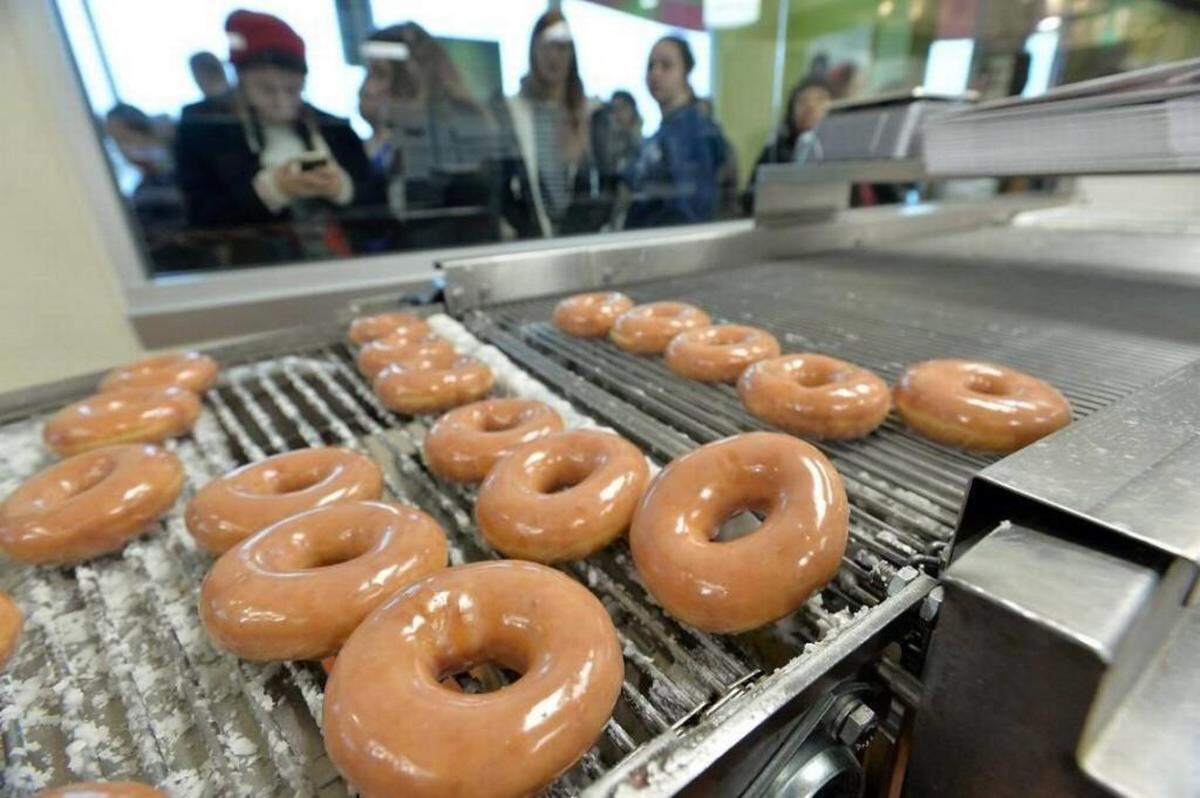 Silvia Flores/Fresno Bee<br/>Krispy Kreme, founded in 1937, has quietly opened its new corporate office in a refurbished textile mill in South End.