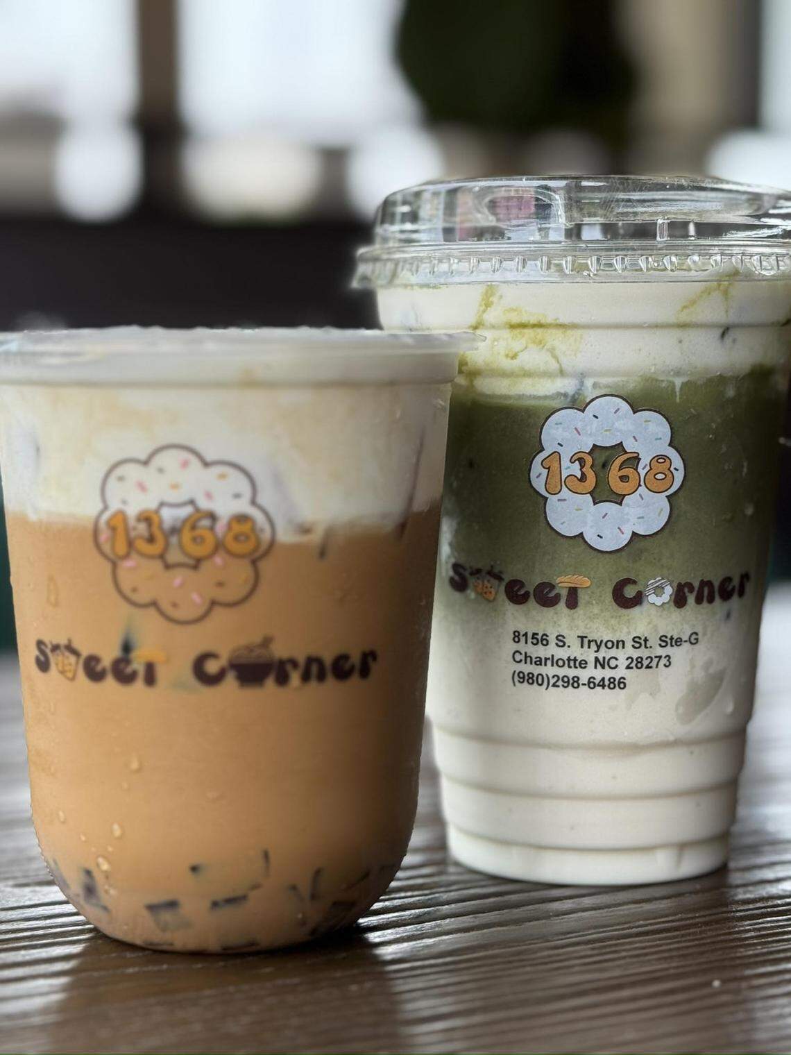 Two iced beverages from “1368 Sweet Corner” are presented in clear plastic cups, showcasing layered colors and creamy foam tops. The drink on the left is a light brown coffee or milk tea with dark pearls at the bottom, while the right is a green matcha blend with white swirls.