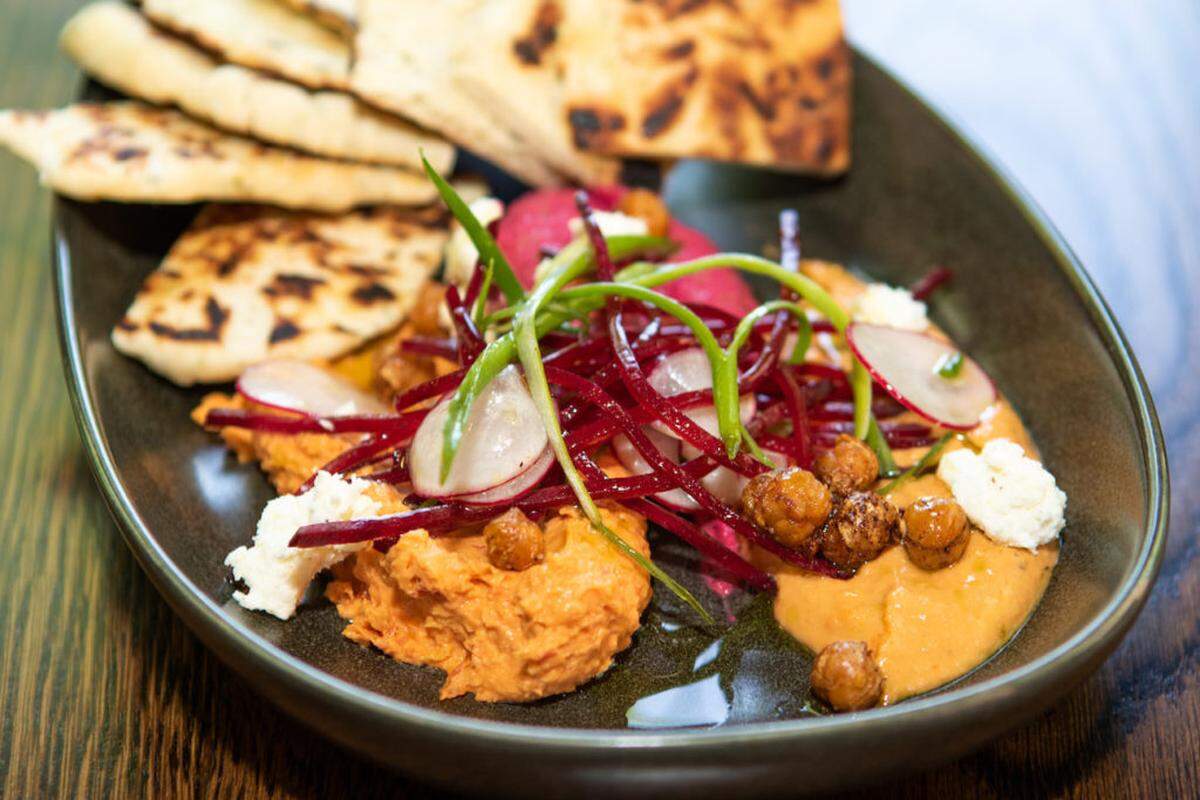 Alex Cason Photography<br/> The hummus trio at The Lucky Duck includes house-made naan, red pepper and eggplant, sundried tomato, red beet topped with feta and crispy chickpeas.