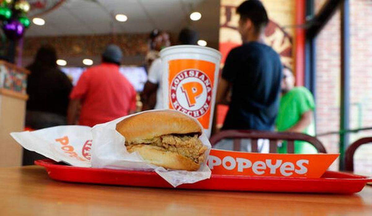 The Associated Press<br/>A chicken sandwich sits on a table at a Popeyes as guests wait in line, Thursday, Aug. 22, 2019, in Kyle, Texas.
