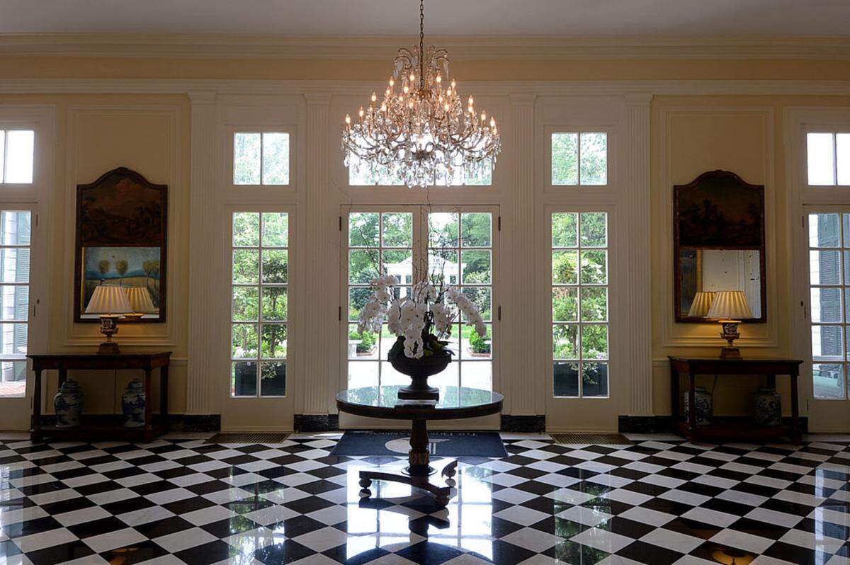 The Duke Mansion garden is visible through a back door of the Great Hall at the Duke Mansion. The Duke Mansion celebrates its 100th anniversary this year and is in the middle of a major renovation of its garden.