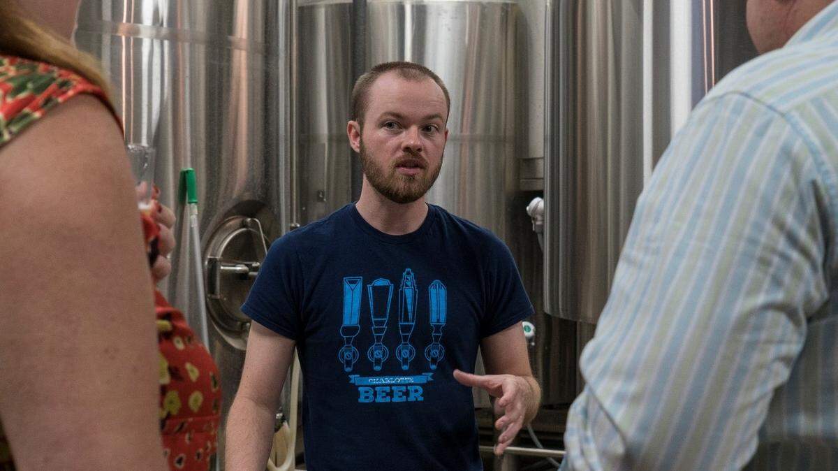 Scott Coggins benefits from the craft beer boom despite the fact that he is not a  aren't brewers. He leading a tour of Birdsong Brewing Co. in NoDa. His business is Charlotte Brews Cruise.