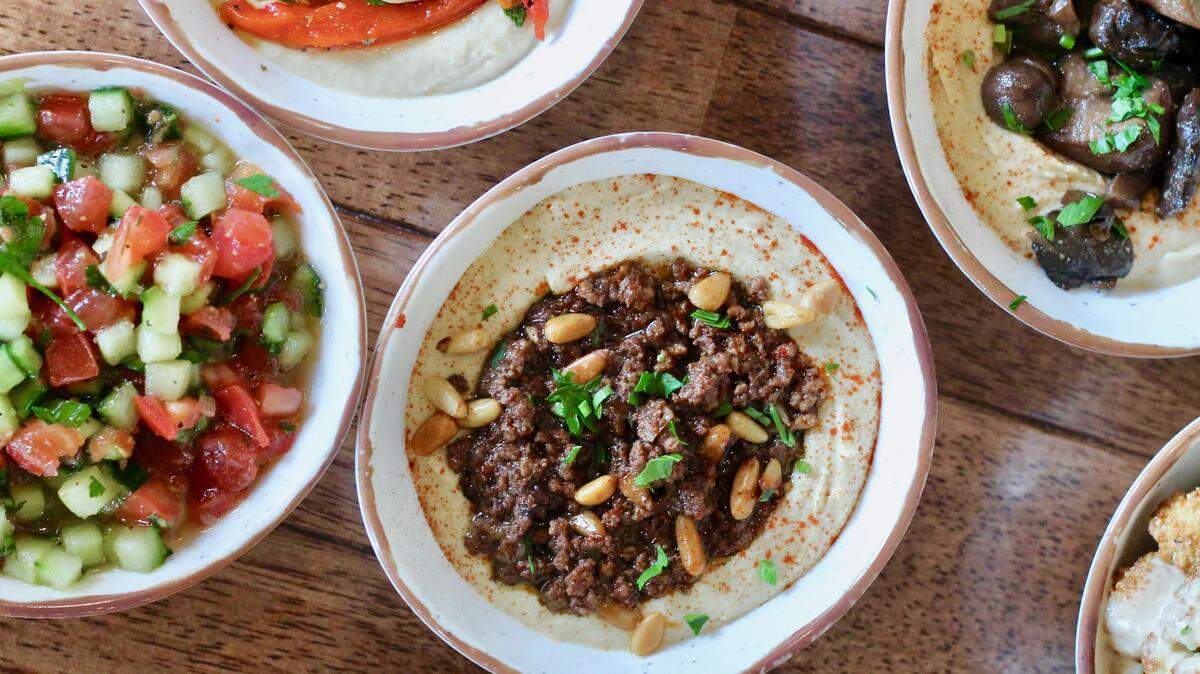 Photo by Jess Bentley<br/>Yafo Kitchen hummus bowl with Baharat Spiced Beef and Pine nuts
