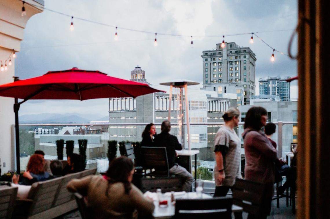 The Pillar rooftop bar in downtown Asheville. Travel + Leisure named the city as one of the best places to travel in 2026.