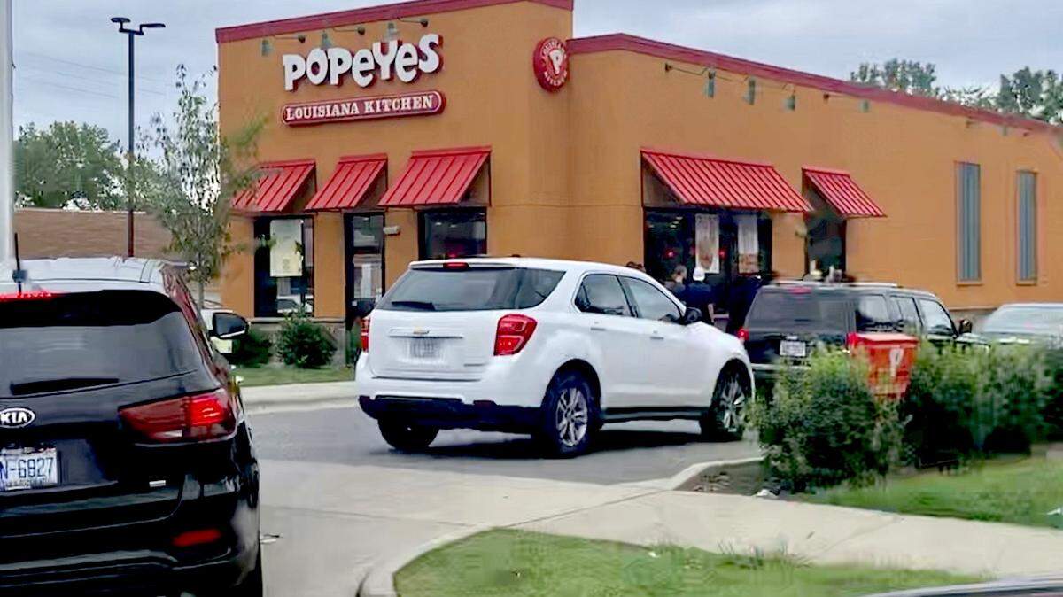 Photo by Melissa Oyler<br/>The drive-thru line at Popeyes on North Tryon Street was 35-plus cars deep on Sunday, August 25, 2019. Popeyes announced a new chicken sandwich on Twitter recently.