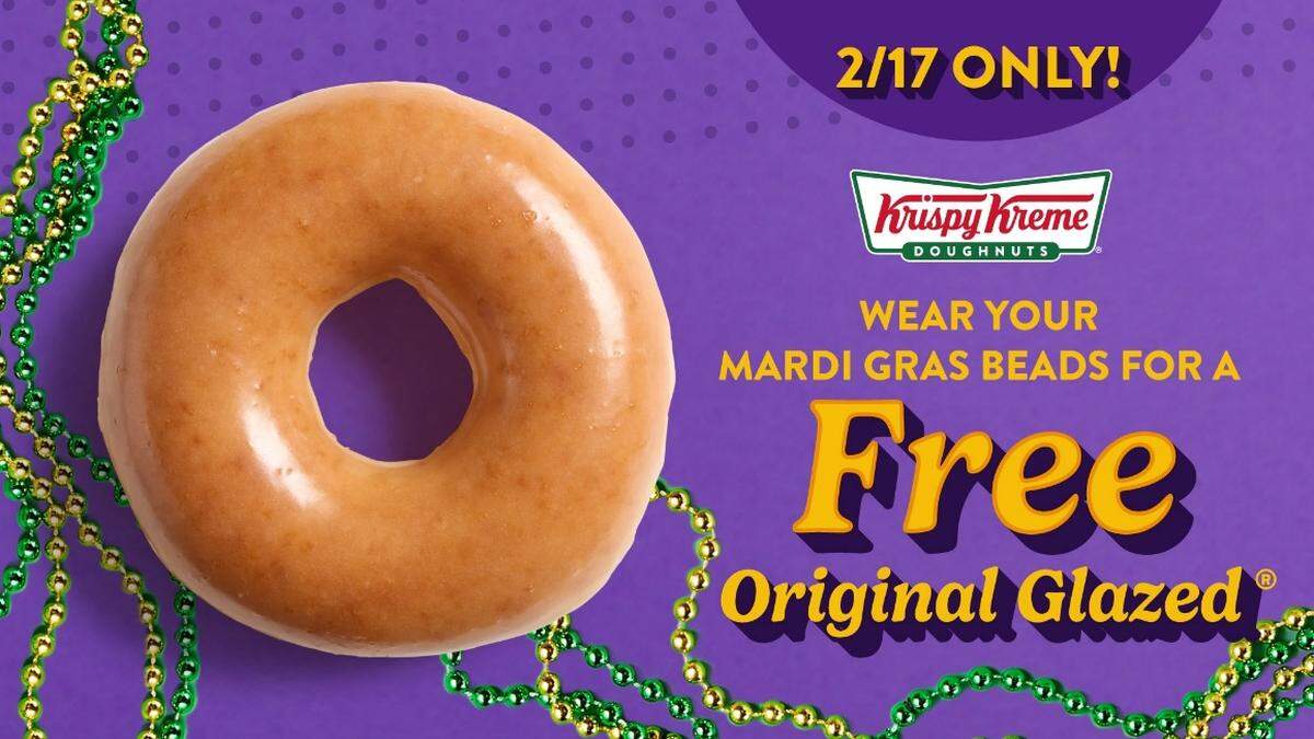 A Krispy Kreme promotional graphic for Mardi Gras featuring a close-up of an Original Glazed doughnut on a purple background with green and gold beads. Text reads: ‘2/17 ONLY! Wear your Mardi Gras beads for a FREE Original Glazed.’”