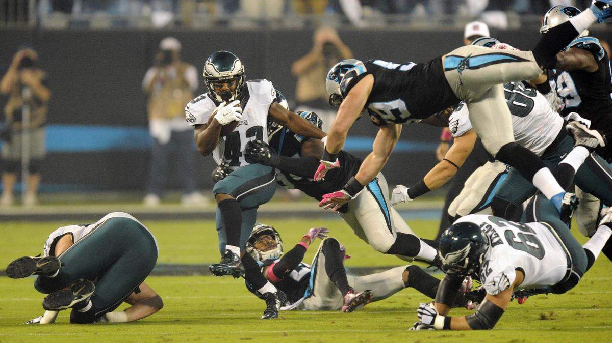 Carolina Panthers' Kony Ealy (94) and Luke Kuechly (59) work to bring down Philadelphia Eagles' Darren Sproles (43) during their game at Bank of America Stadium on Sunday, October 25, 2015. The Panthers won 27-16.