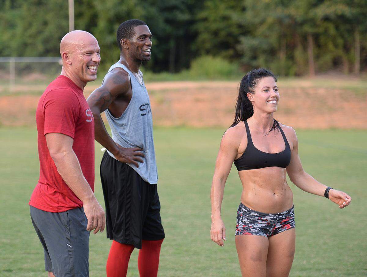 Eric McCoy, left, owner of STAX, former NFL star Randy Moss, who now lives in Charlotte, and 2X Crossfit games athlete Emily Breeze lead exercises during a free twice-a-week boot camp being co-led by Breeze and Moss. They came up with the idea as a way to give back to the community they both love so much. Participation is expected to eclipse 500 people.