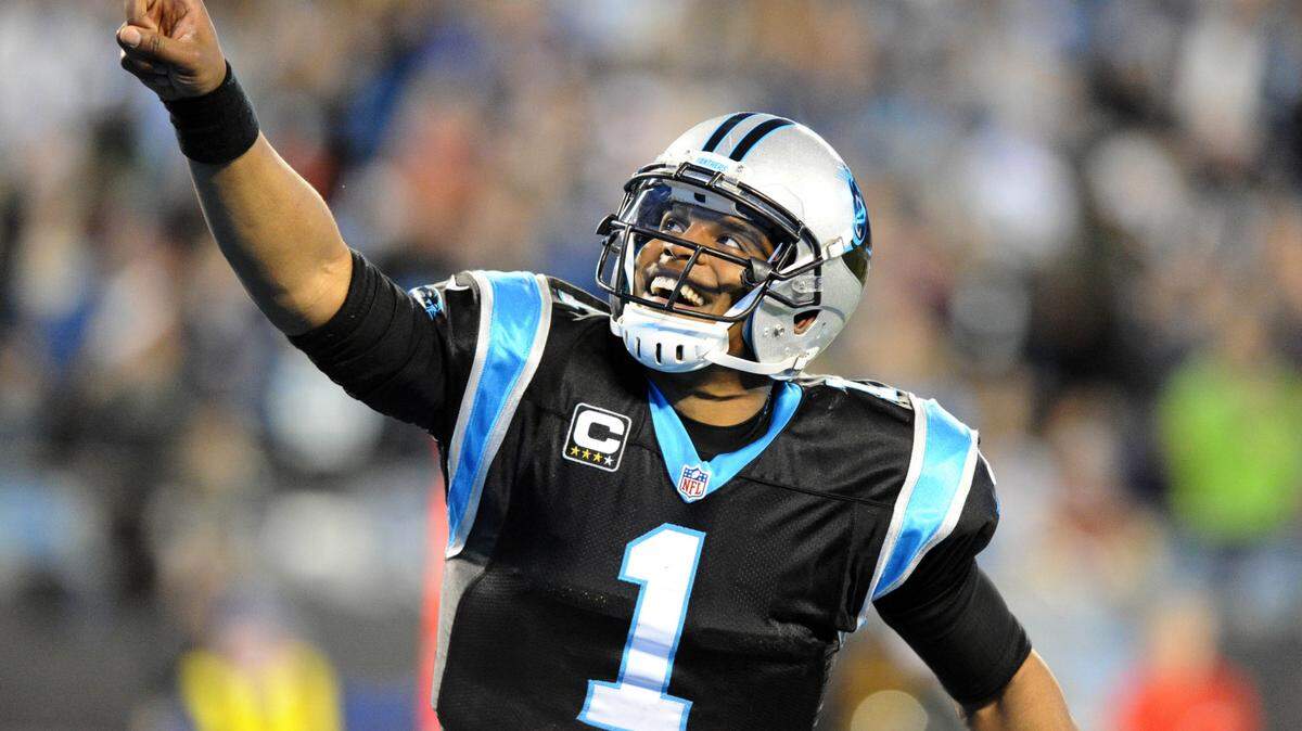 Carolina Panthers' Cam Newton (1) points to the crowd while celebrating a touchdown against the Tampa Bay Buccaneers in the second quarter at Bank of America Stadium on Sunday, January 3, 2016.  The Panthers won 38-10, and secured home field through the playoffs.