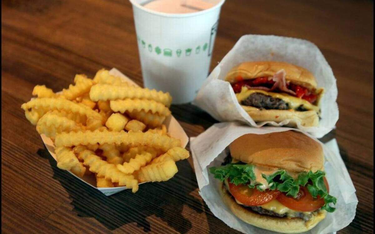 A “Smoke Shack” (top) and a “Shack Burger” along with fries and a strawberry shake at this Shake Shack spot in Coral Gables, Fla. PATRICK FARRELL MIAMI HERALD STAFF