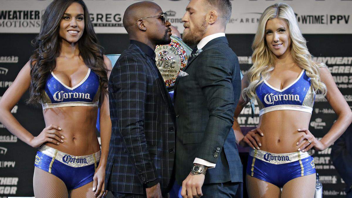 Floyd Mayweather Jr., center left, and Conor McGregor pose for photographers during a news conference Wednesday, Aug. 23, 2017, in Las Vegas. The two are scheduled to fight in a boxing match Saturday in Las Vegas. (AP Photo/John Locher)