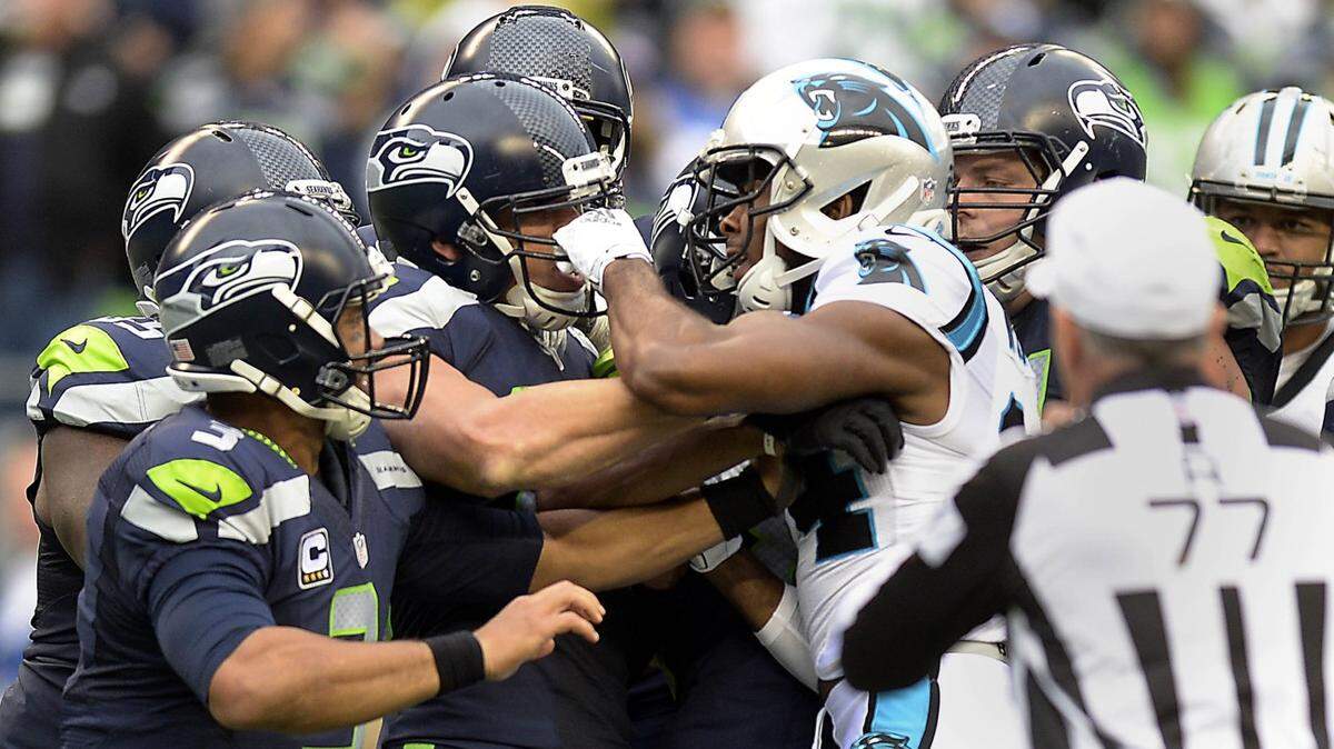 Carolina Panthers' Josh Norman (24, center right) gets into an argument with Seattle Seahawks' Jimmy Graham (88, center left)  in the first half at CenturyLink Field on Sunday, October 18, 2015. The Panthers won, 27-23.