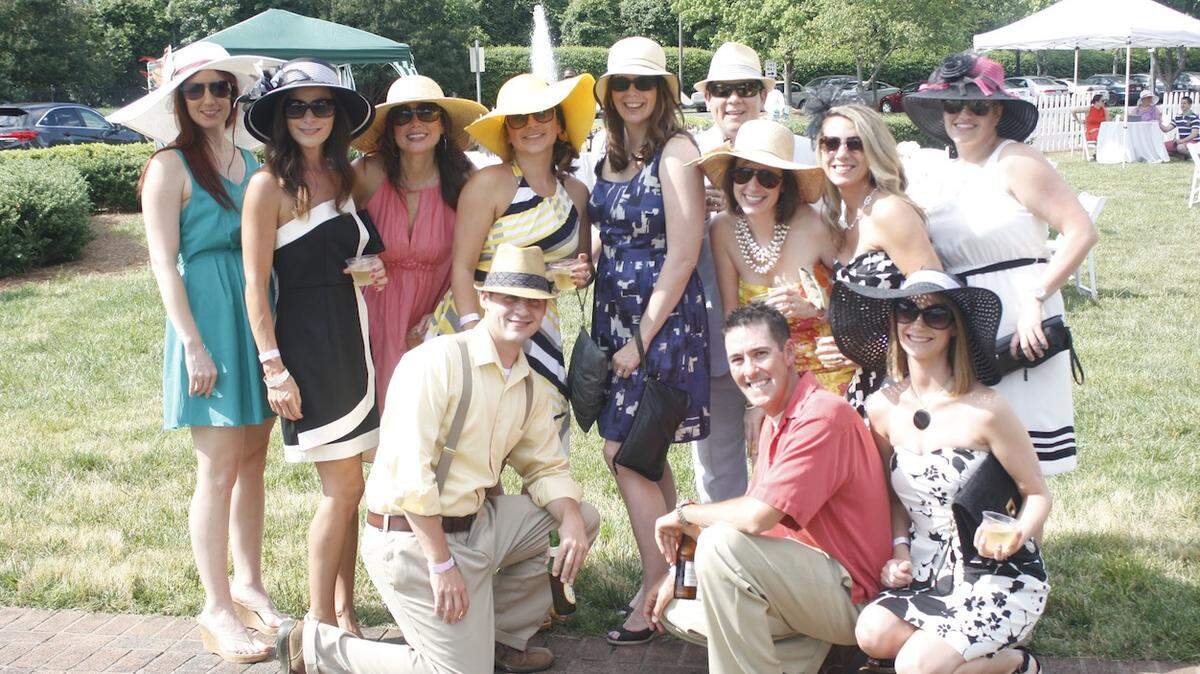Young professionals in their race day finery on the lawn of the Mint Museum Randolph during the Young Affiliates of the Mint Museum's annual Derby Days fundraiser.
