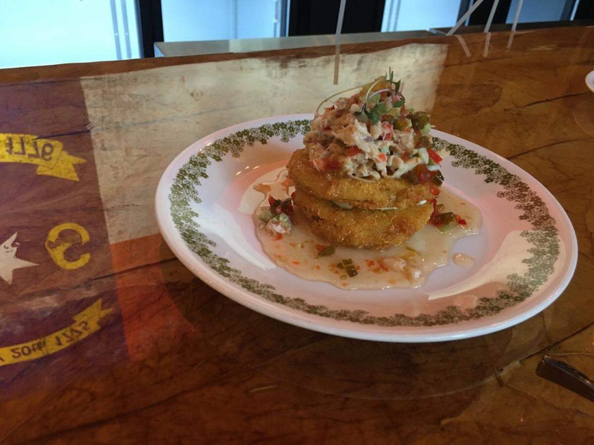 Fried green tomato with crab salad, housemade pepper jelly and whipped goat cheese.