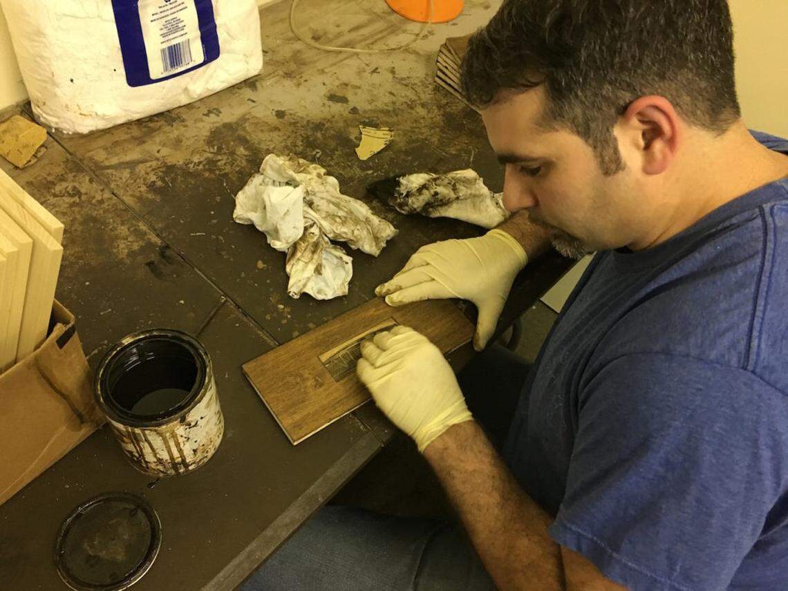 Cohen, staining part of what will become a new gift box.